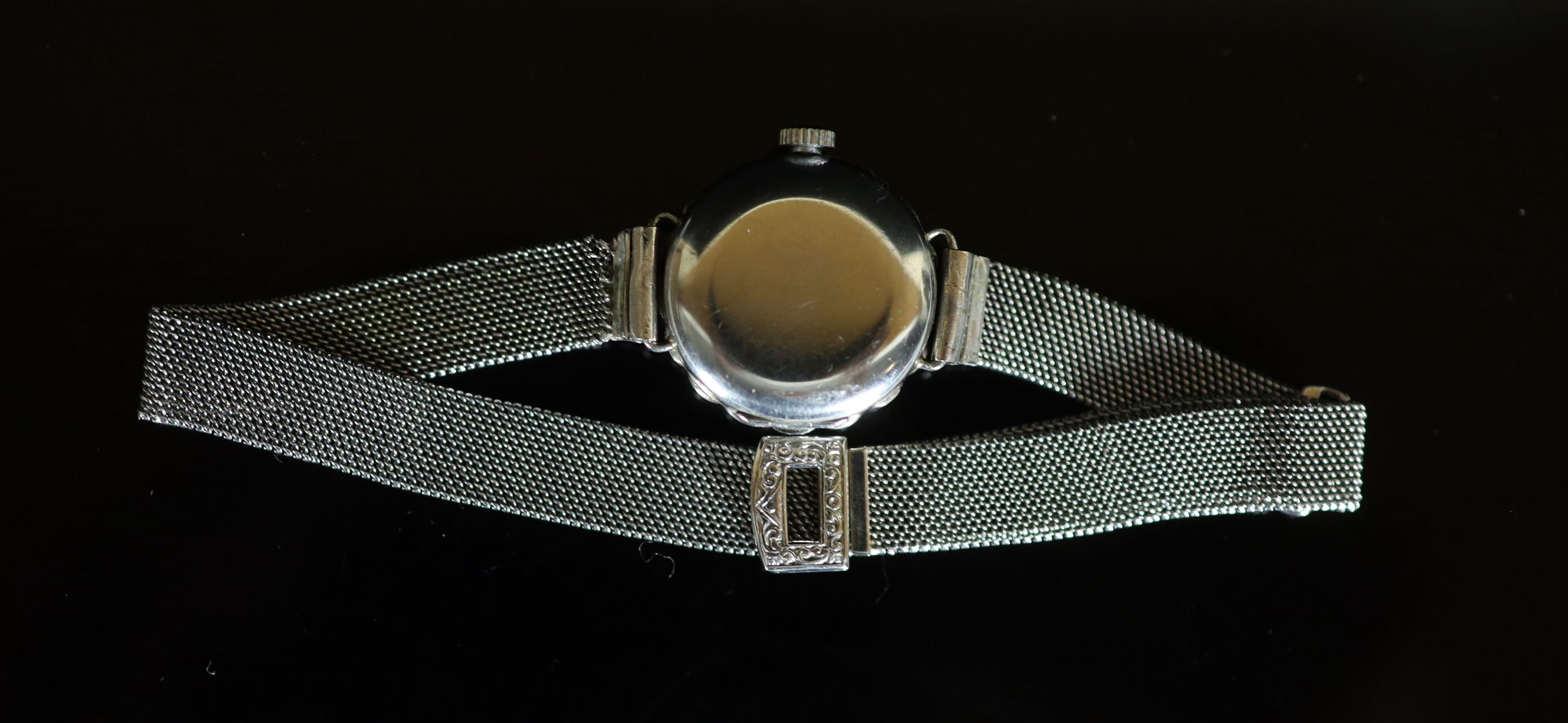 A lady's platinum and diamond set manual wind cocktail watch, on an 18ct white gold mesh link bracelet